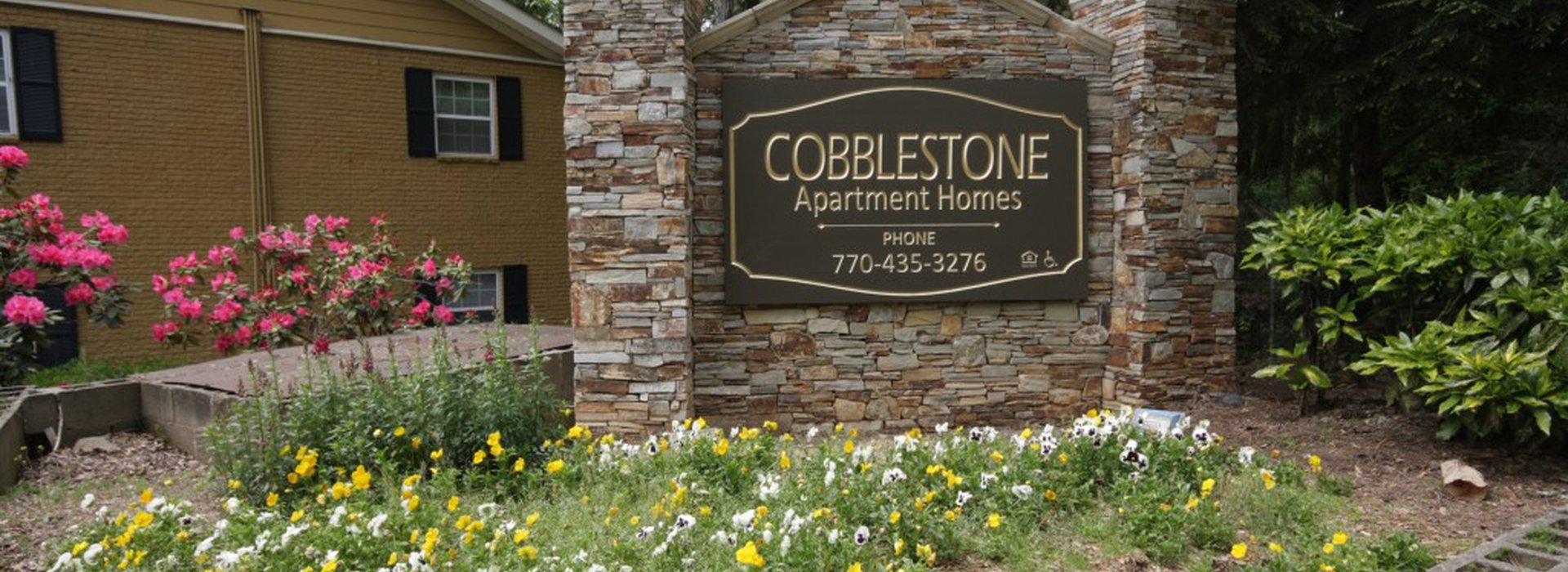 Cobblestone Apartment Home sign at the entrance